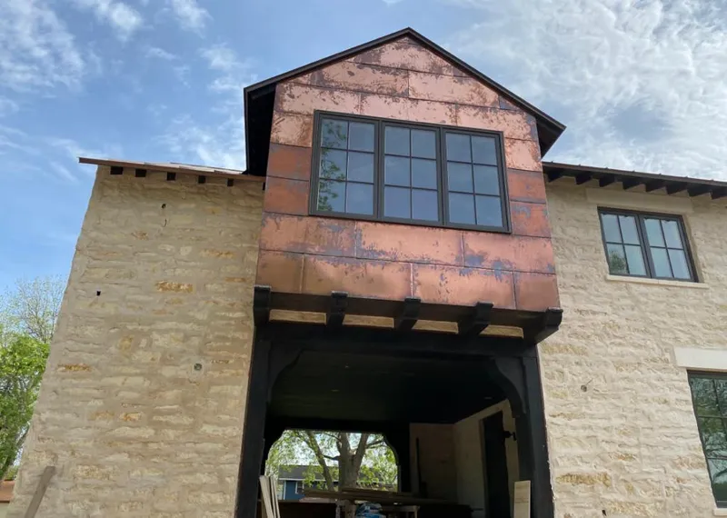 Copper metal panel facade on a stone building for Skylight Installation in Mansfield